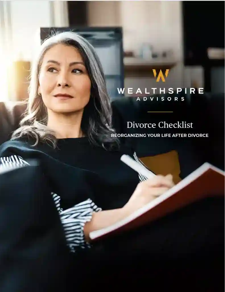 Mature women writing in a journal, sitting on a couch.