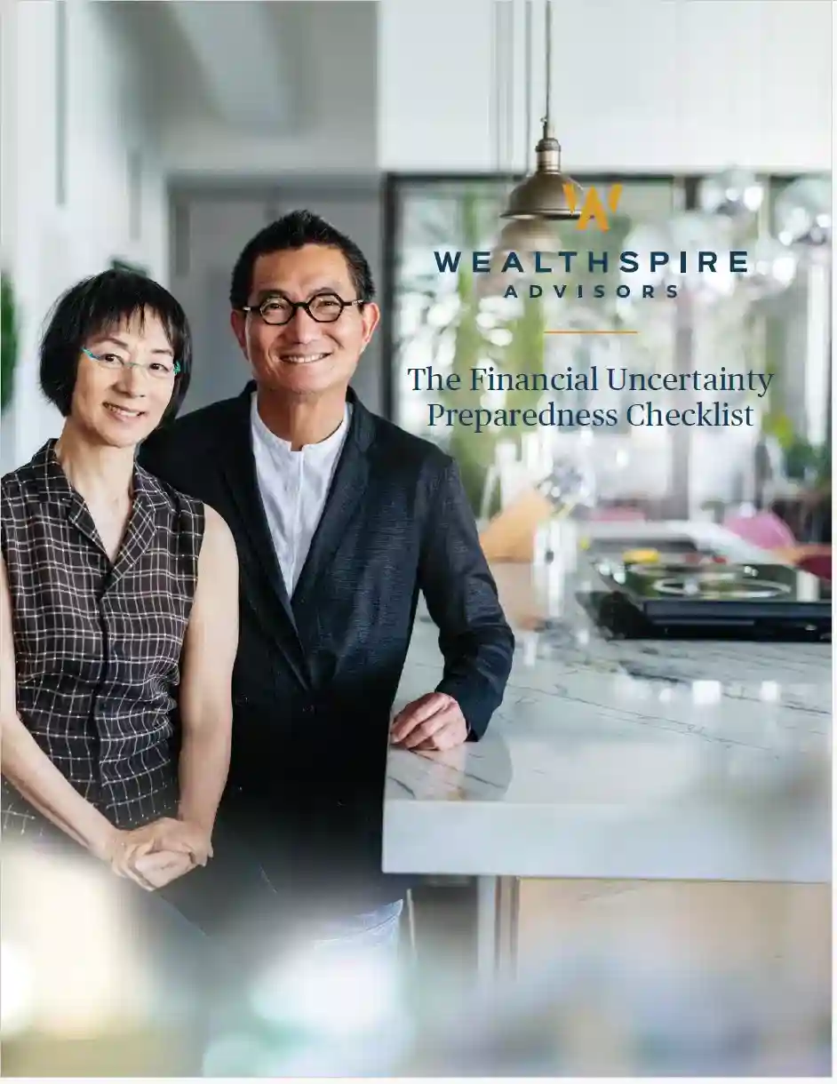 Two mature adults standing in a modern kitchen, smiling at camera.