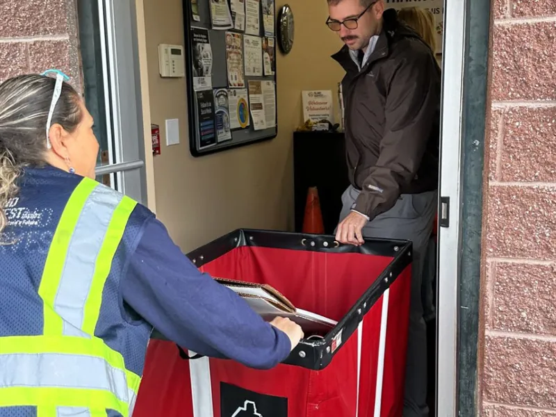 volunteers pushing bins inside