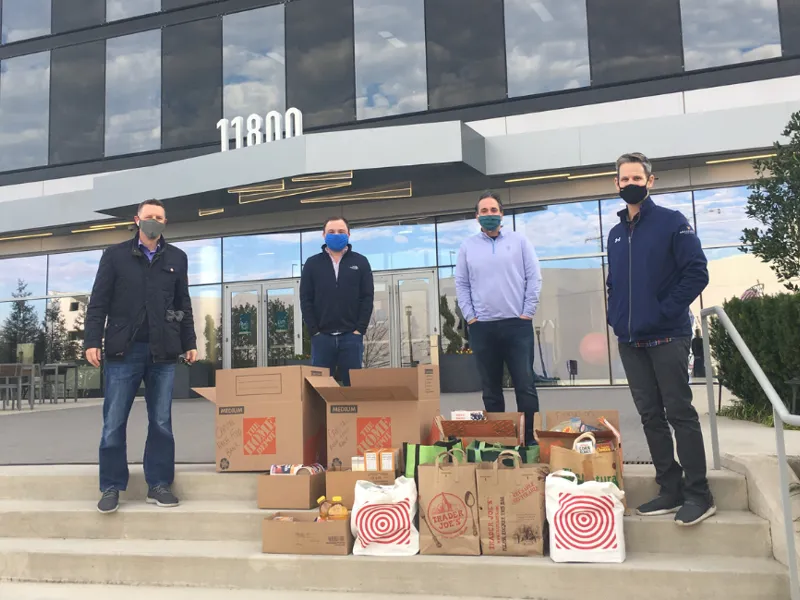 four men with food drive items